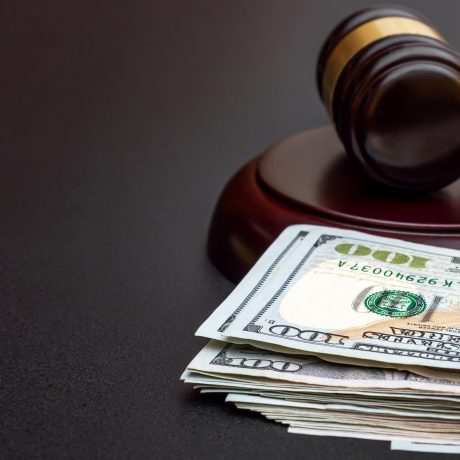 Judge’s gavel with money on black. Judge's gavel with money on black.